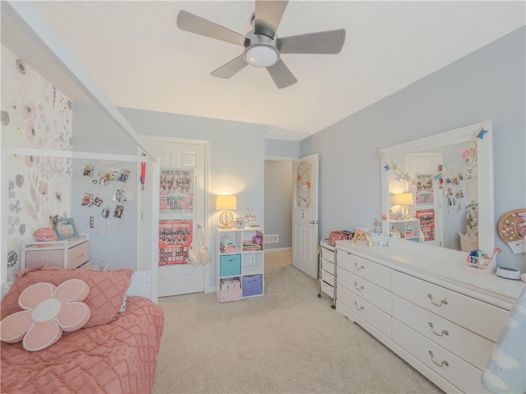 3100 Oak Ridge Lane Loganville, GA 30052 - Photo 27 of 43 a bedroom with a bed and a dresser