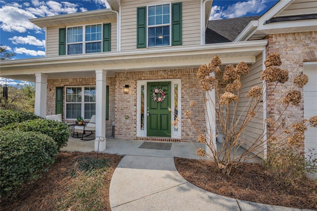 3100 Oak Ridge Lane Loganville, GA 30052 - Photo 3 of 43 front view of a brick house with a large window