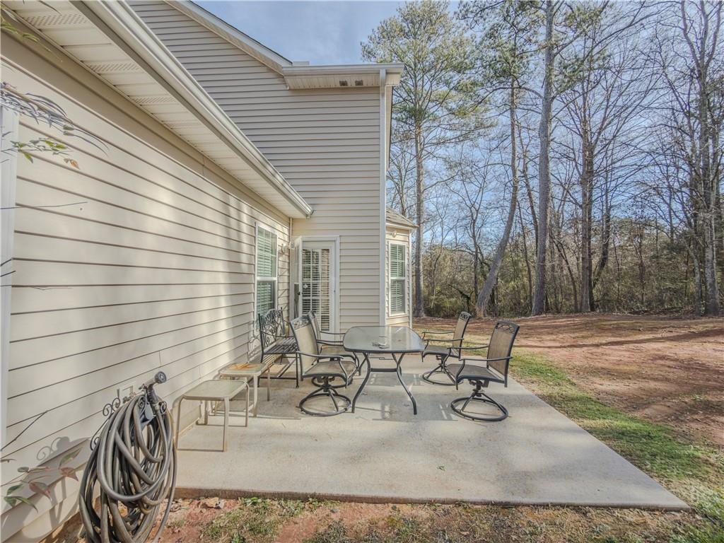 3100 Oak Ridge Lane Loganville, GA 30052 - Photo 35 of 43 a view of a patio with chairs and table in a patio
