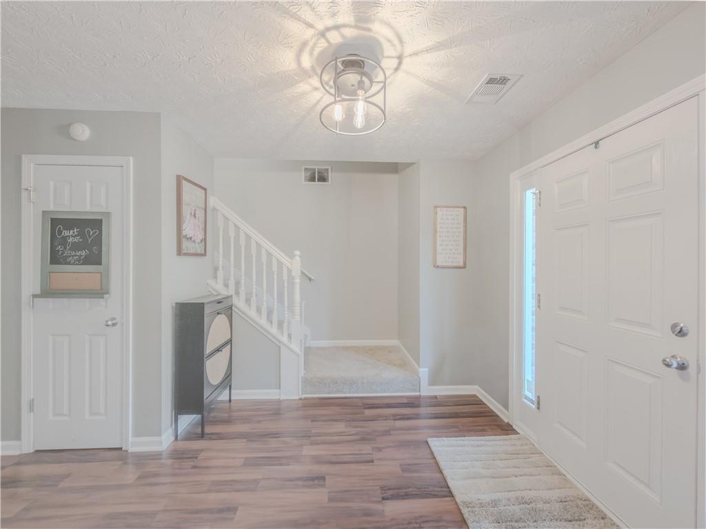 3100 Oak Ridge Lane Loganville, GA 30052 - Photo 4 of 43 a view of entryway and hall with wooden floor