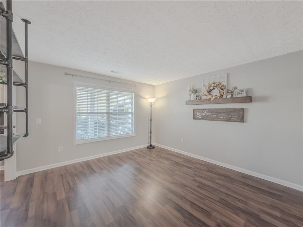 3100 Oak Ridge Lane Loganville, GA 30052 - Photo 6 of 43 an empty room with wooden floor and windows