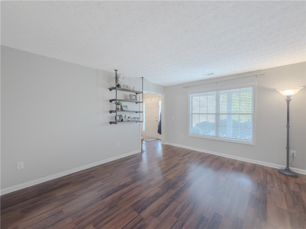 3100 Oak Ridge Lane Loganville, GA 30052 - Photo 7 of 43 an empty room with wooden floor and windows