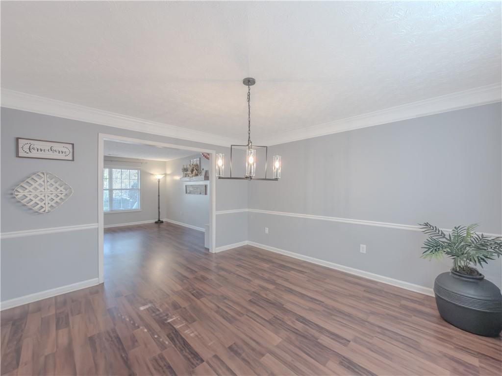 3100 Oak Ridge Lane Loganville, GA 30052 - Photo 8 of 43 a view of a room with wooden floor potted plant and windows