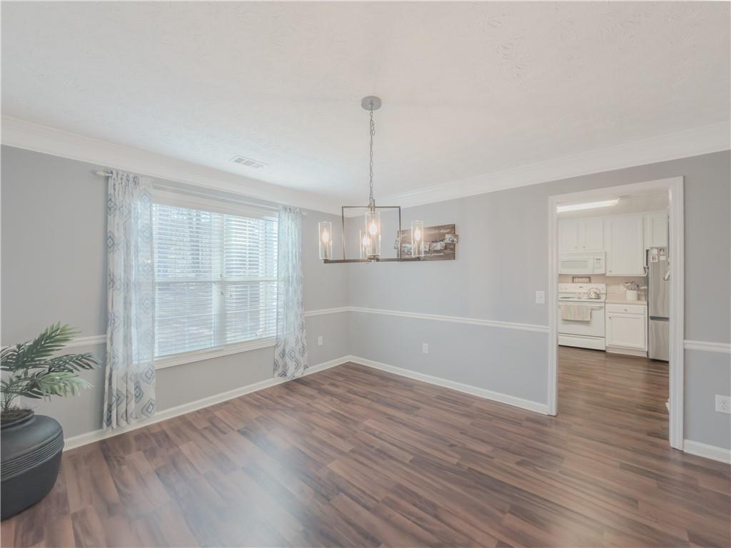 3100 Oak Ridge Lane Loganville, GA 30052 - Photo 9 of 43 an empty room with wooden floor and windows