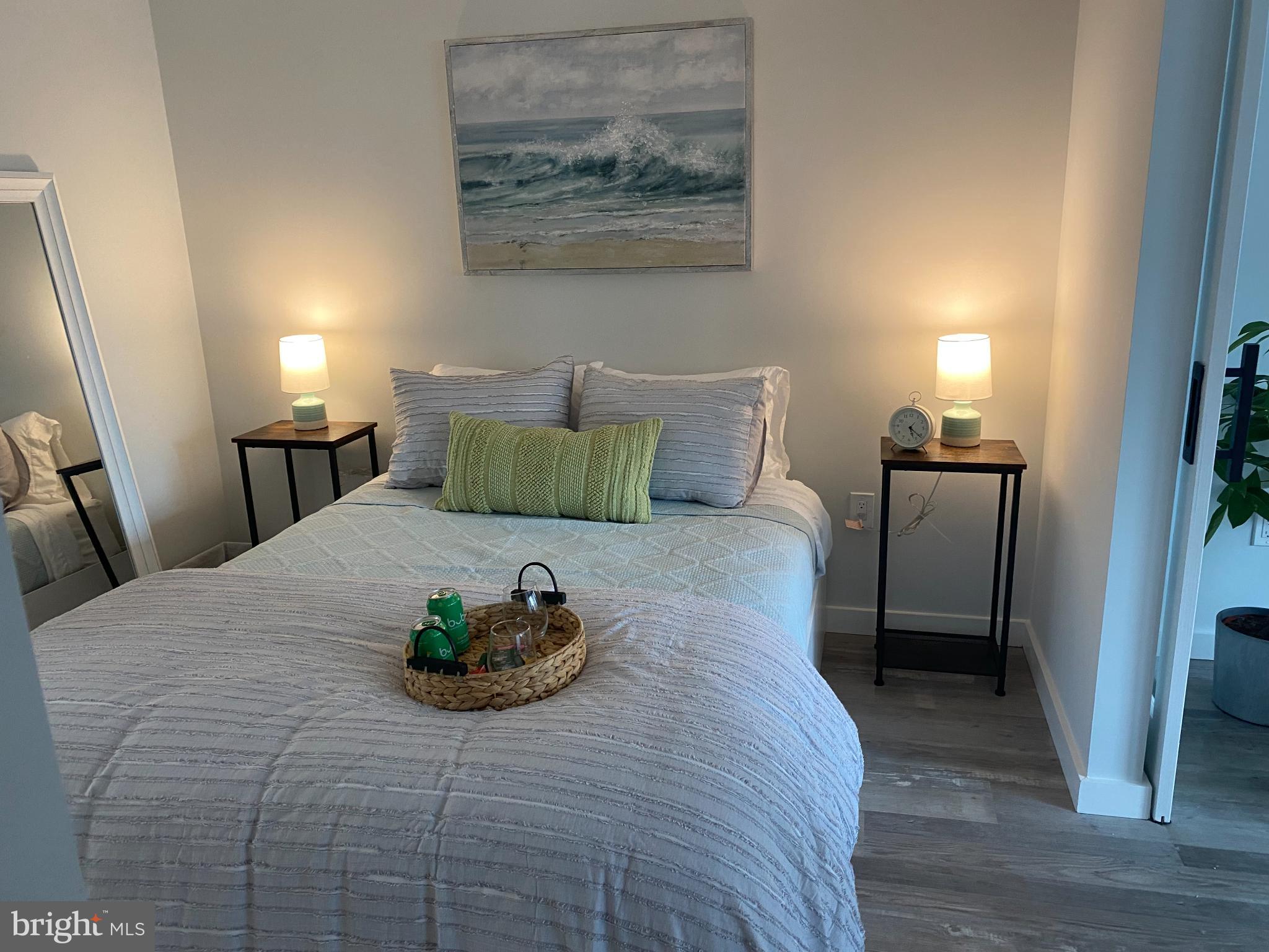 700 Roeder Road, Unit 405 Silver Spring, MD 20910 - Photo 12 of 18 a bedroom with a bed and wooden floor