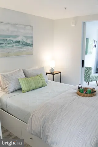 a bedroom with a bed and a painting on the wall