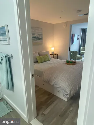 a bedroom with a bed and a mirror on the wall