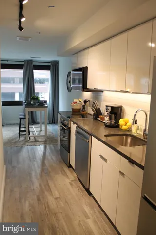 a kitchen with a sink cabinets and appliances