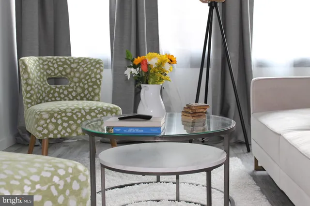 a dining room with furniture and a potted plant