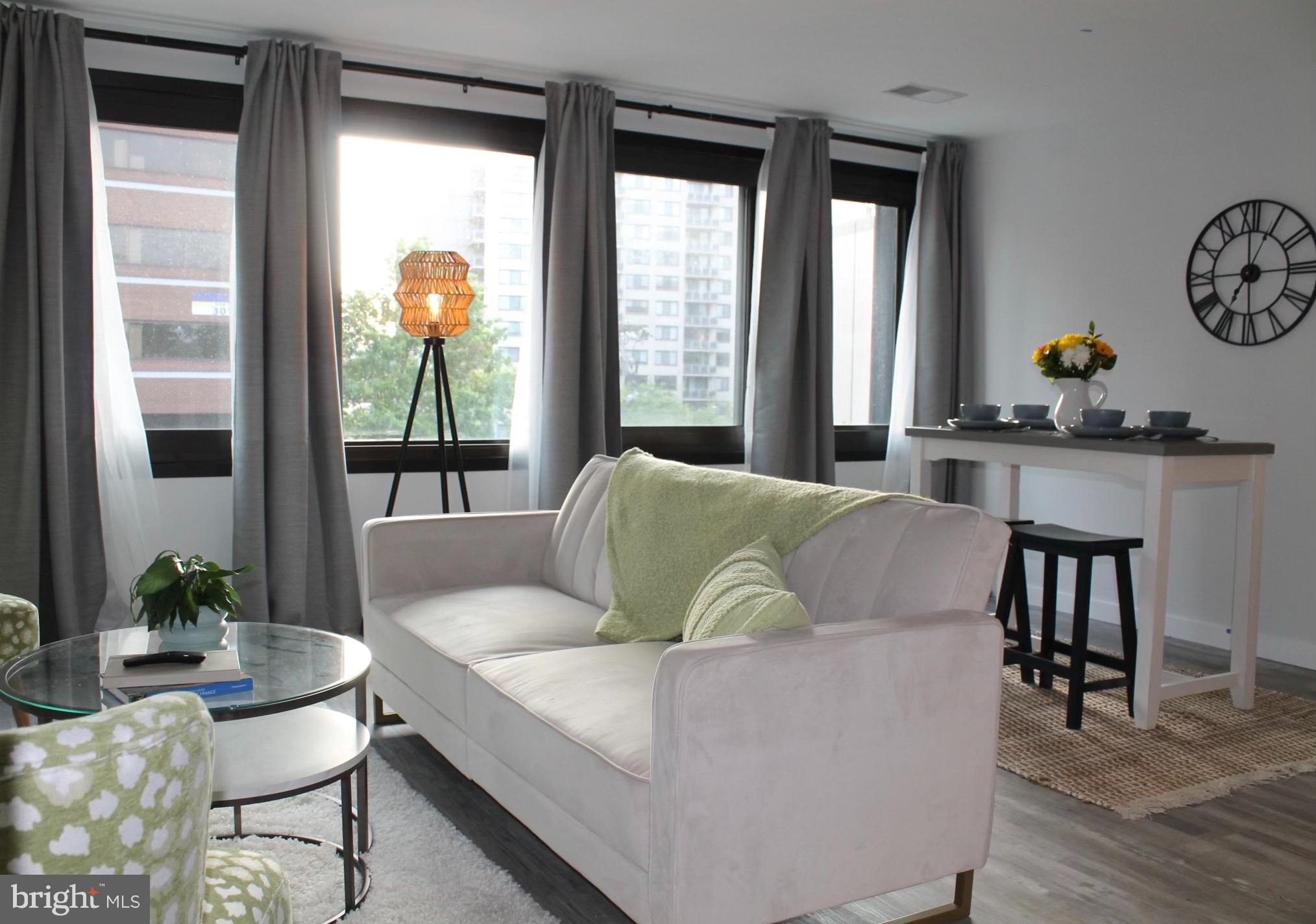 700 Roeder Road, Unit 405 Silver Spring, MD 20910 - Photo 9 of 18 a living room with furniture and a large window