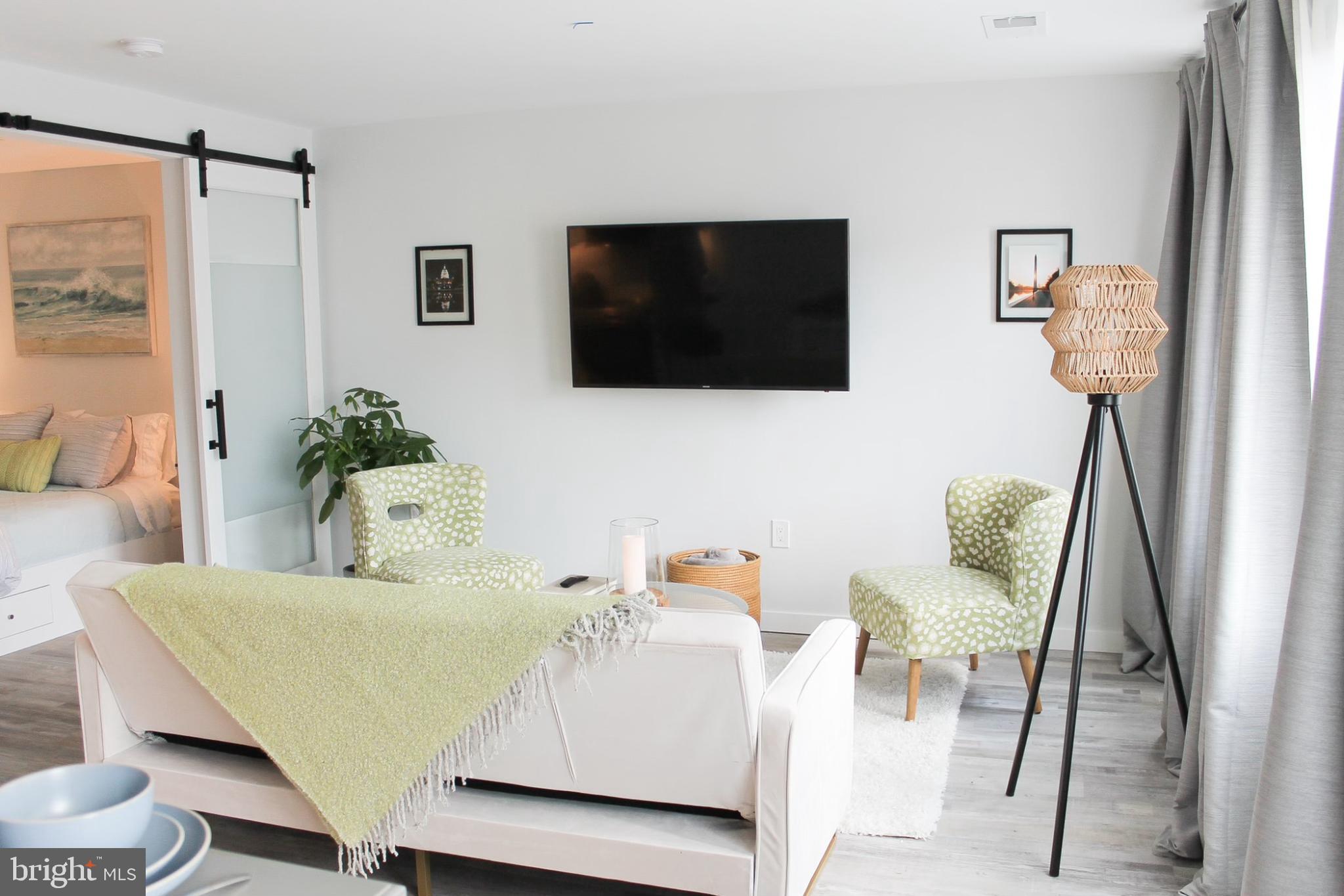 700 Roeder Road, Unit 405 Silver Spring, MD 20910 - Photo 10 of 18 a living room with furniture and a flat screen tv