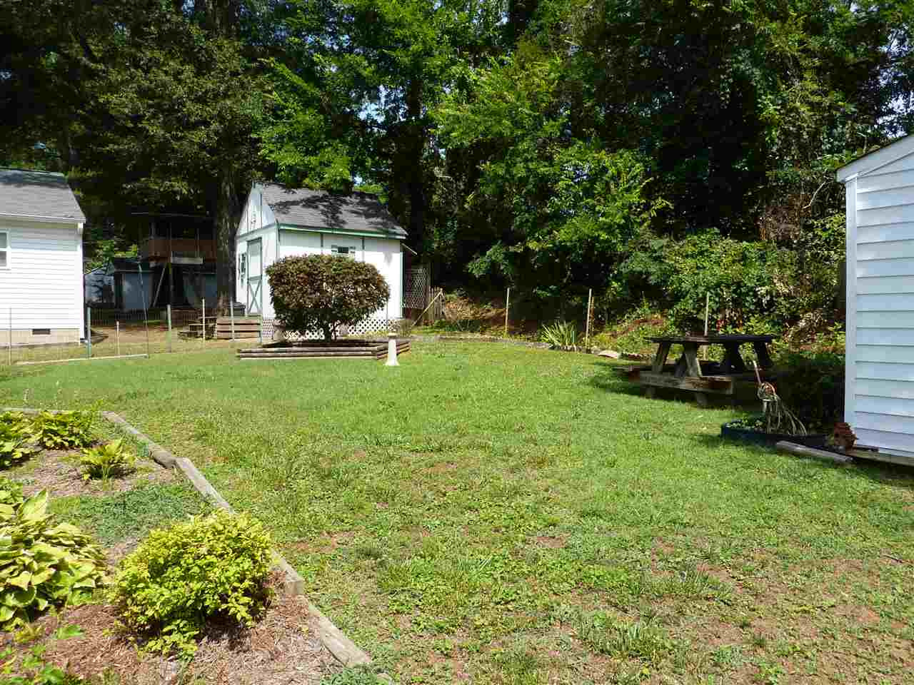 A charming and private fenced in yard features a pavers patio- the perfect place to enjoy your morning coffee! Yard