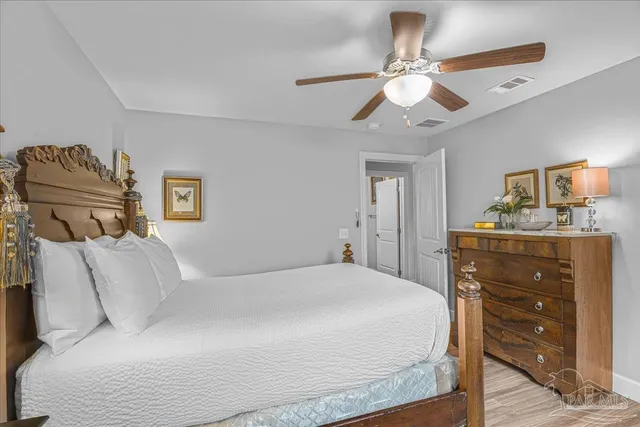 a spacious bedroom with a bed and a window