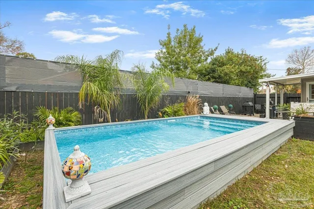 a view of a backyard with sitting area