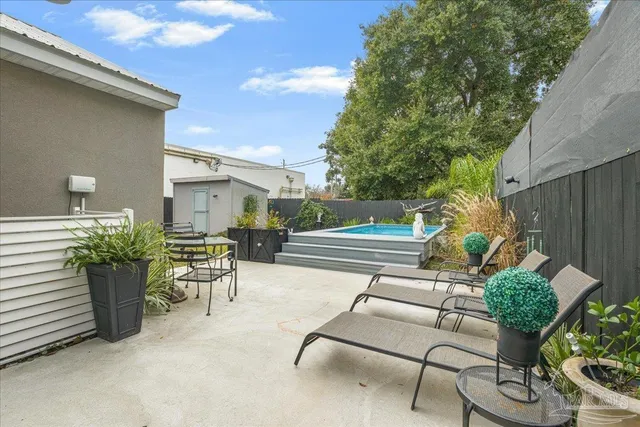 a view of a backyard with plants and a patio