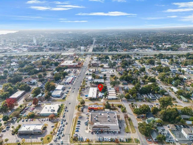 a view of a house with pool and sitting area