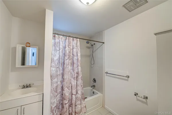 a bathroom with a shower curtain and a sink