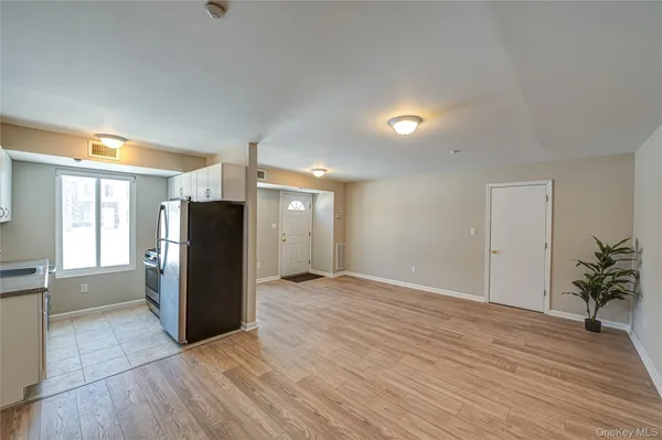 an empty room with wooden floor and a window