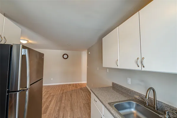 a kitchen with stainless steel appliances granite countertop a refrigerator sink and cabinets