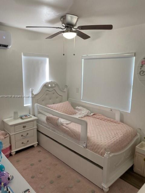 West Flagler Miami, FL 33125 - Photo 5 of 11 a bedroom with a bed and a chandelier fan