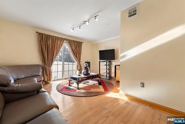 a living room with furniture and a floor to ceiling window