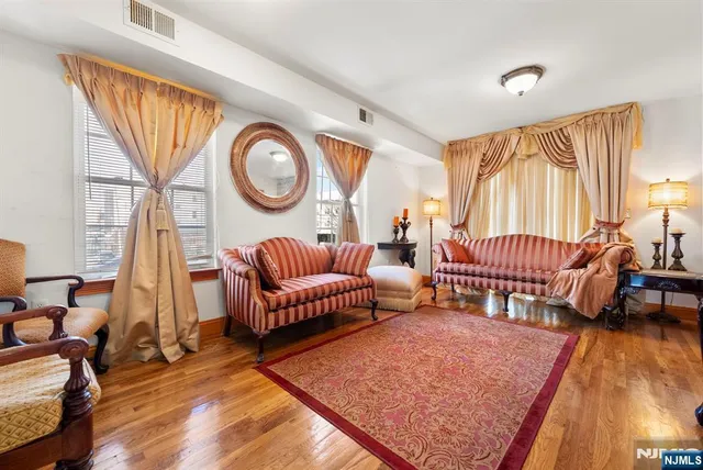 a living room with furniture a fireplace and a large window