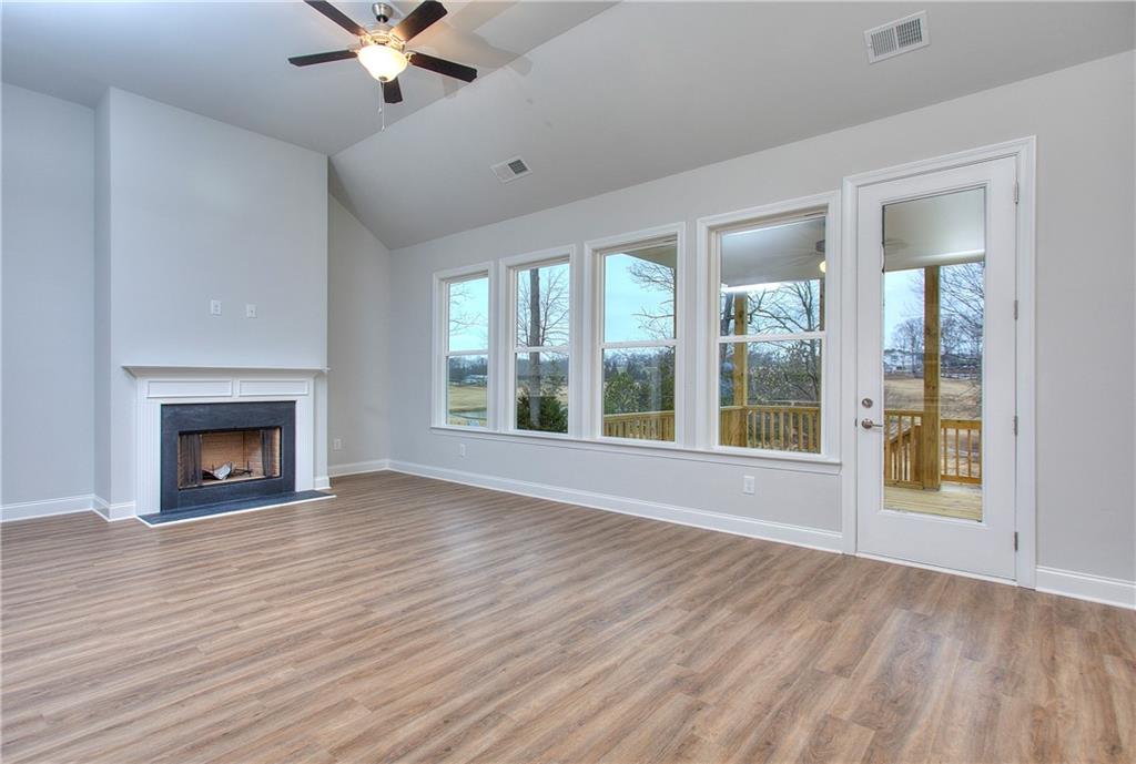 2604 Parkside Way Gainesville, GA 30507 - Photo 22 of 35 wooden floor fireplace and windows in an empty room