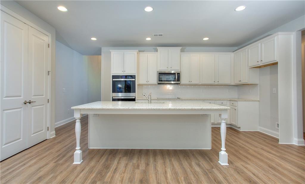 2604 Parkside Way Gainesville, GA 30507 - Photo 26 of 35 a view of kitchen with wooden floor and electronic appliances