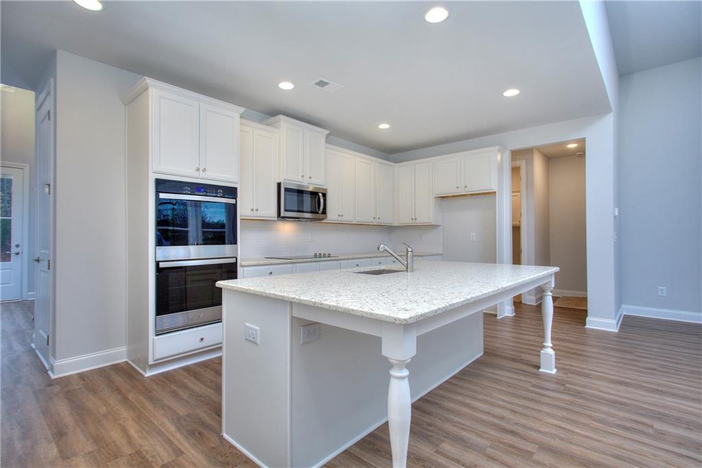 2604 Parkside Way Gainesville, GA 30507 - Photo 27 of 35 a kitchen with a sink a counter top space stainless steel appliances and cabinets