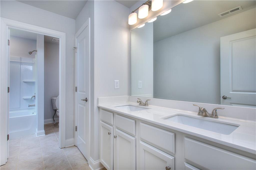 2604 Parkside Way Gainesville, GA 30507 - Photo 5 of 35 a bathroom with a sink vanity granite and a mirror