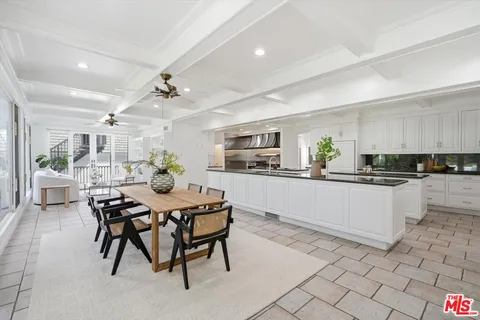a living room with furniture a rug and white walls