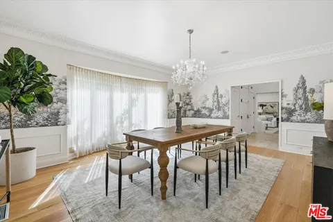 a very nice looking room with a large window and wooden floor