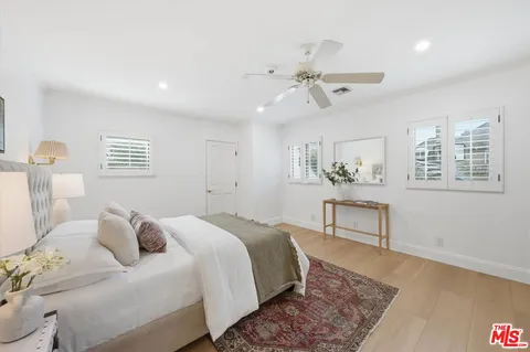 a large white kitchen with a large window