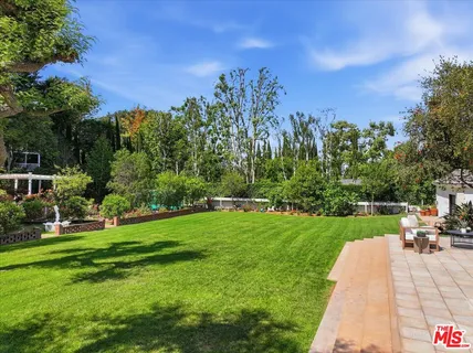 a front view of a house with a yard fountain and fountain