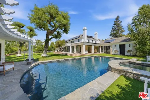 a view of house with swimming pool outdoor seating
