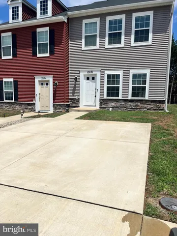 a view of a kitchen with wooden floor and cabinets