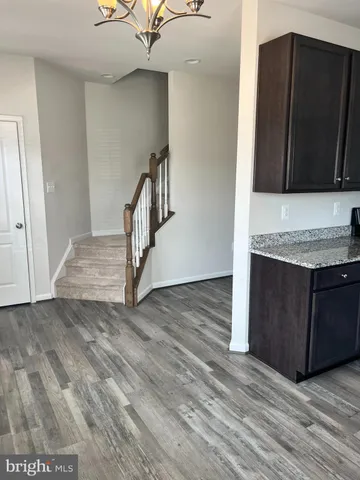 a kitchen with stainless steel appliances granite countertop a sink stove microwave and refrigerator