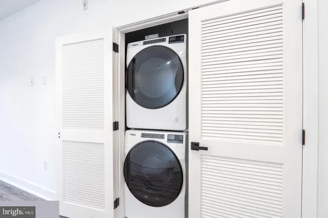 a view of a hallway with washer and dryer