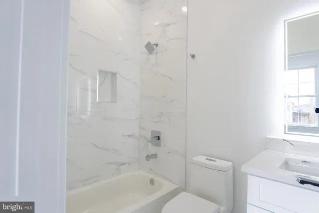 a bathroom with a bathtub a sink a toilet and a shower