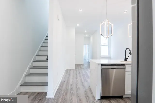 a kitchen with cabinets and a wooden floor