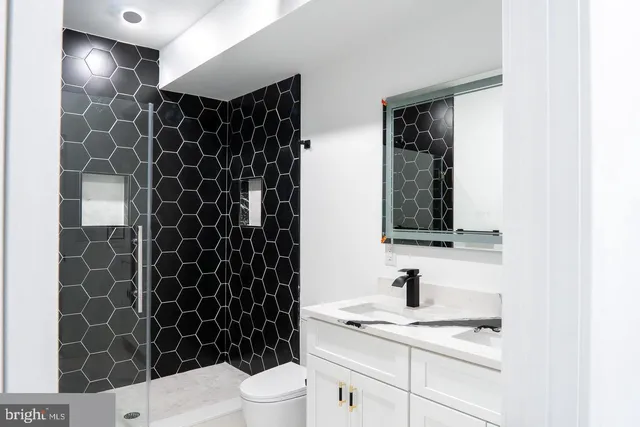 a bathroom with a sink toilet and shower