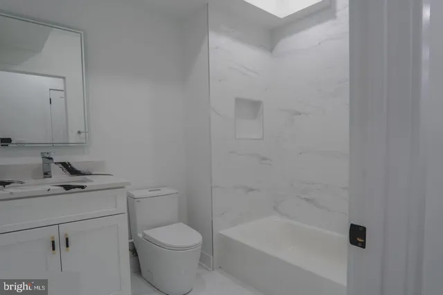 a bathroom with a sink toilet and vanity