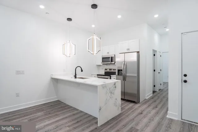 a kitchen with cabinets and stainless steel appliances