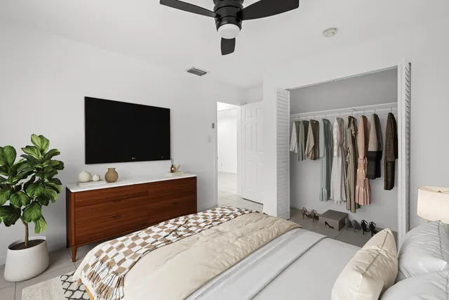 a bedroom with a bed and a flat screen tv