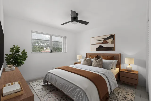 a bedroom with bed and a window