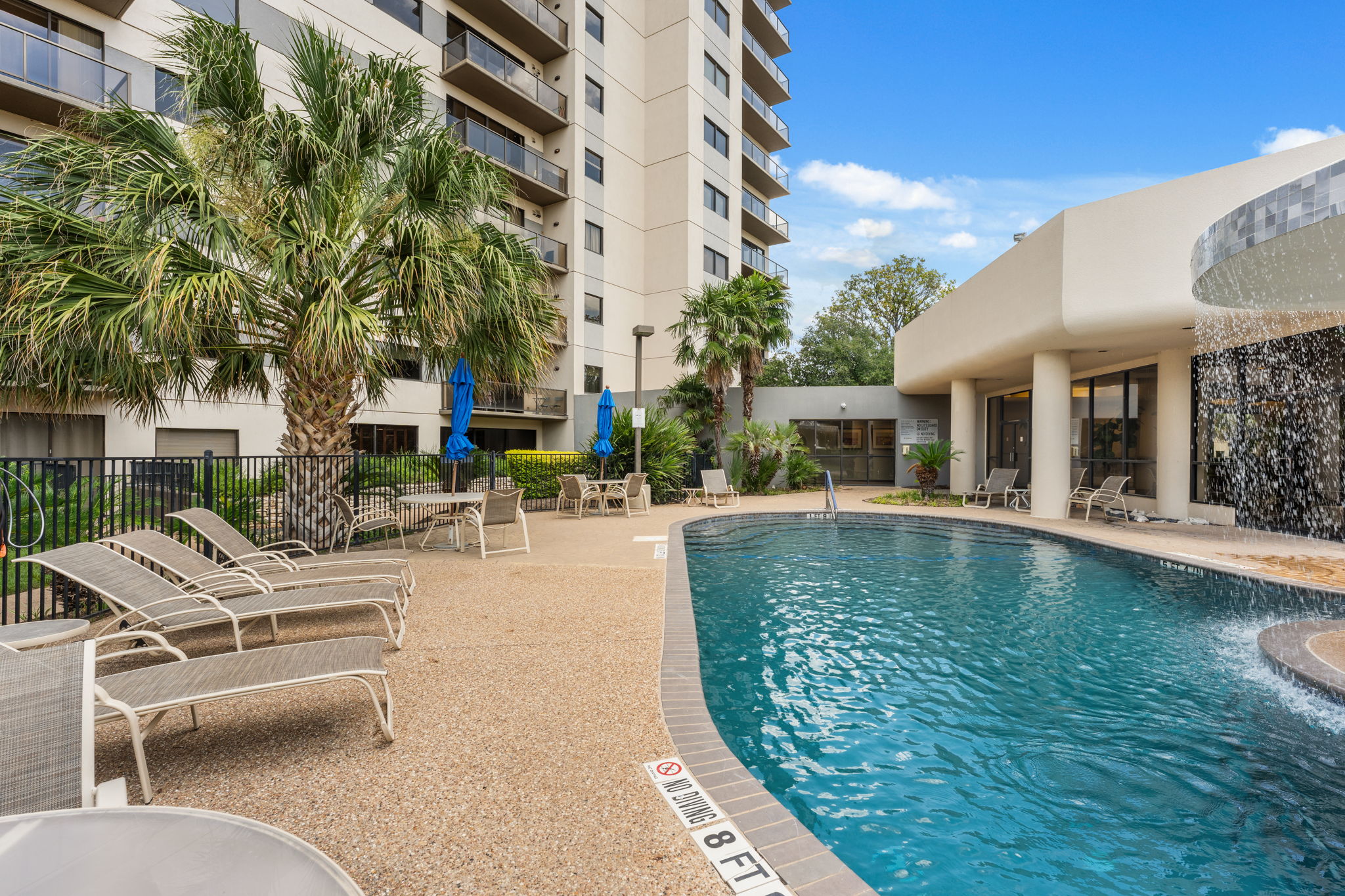 40 North Interstate Highway 35, Unit 11B2 Austin, TX 78701 - Photo 27 of 28 A resort-style pool with cascading water features awaits, offering a tranquil escape within a vibrant community setting.