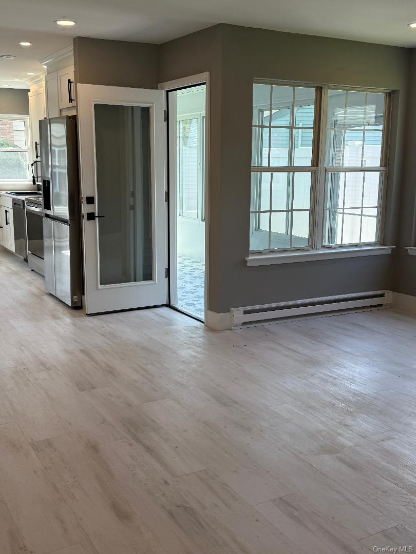 379 Larchmont Court Ridge, NY 11961 - Photo 9 of 17 an empty room with closet and windows