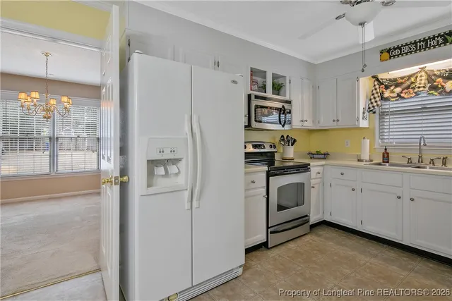 a kitchen with a white cabinets and white appliances