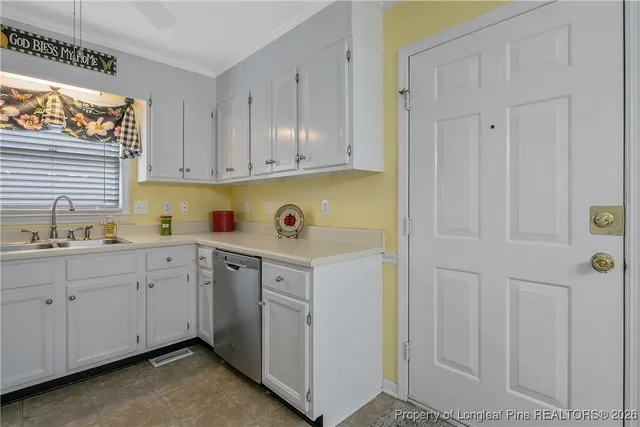a kitchen with white cabinets and white appliances