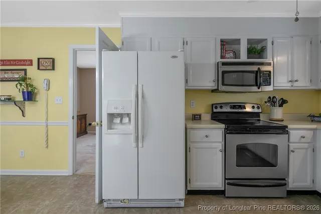 a kitchen with a refrigerator stove and microwave